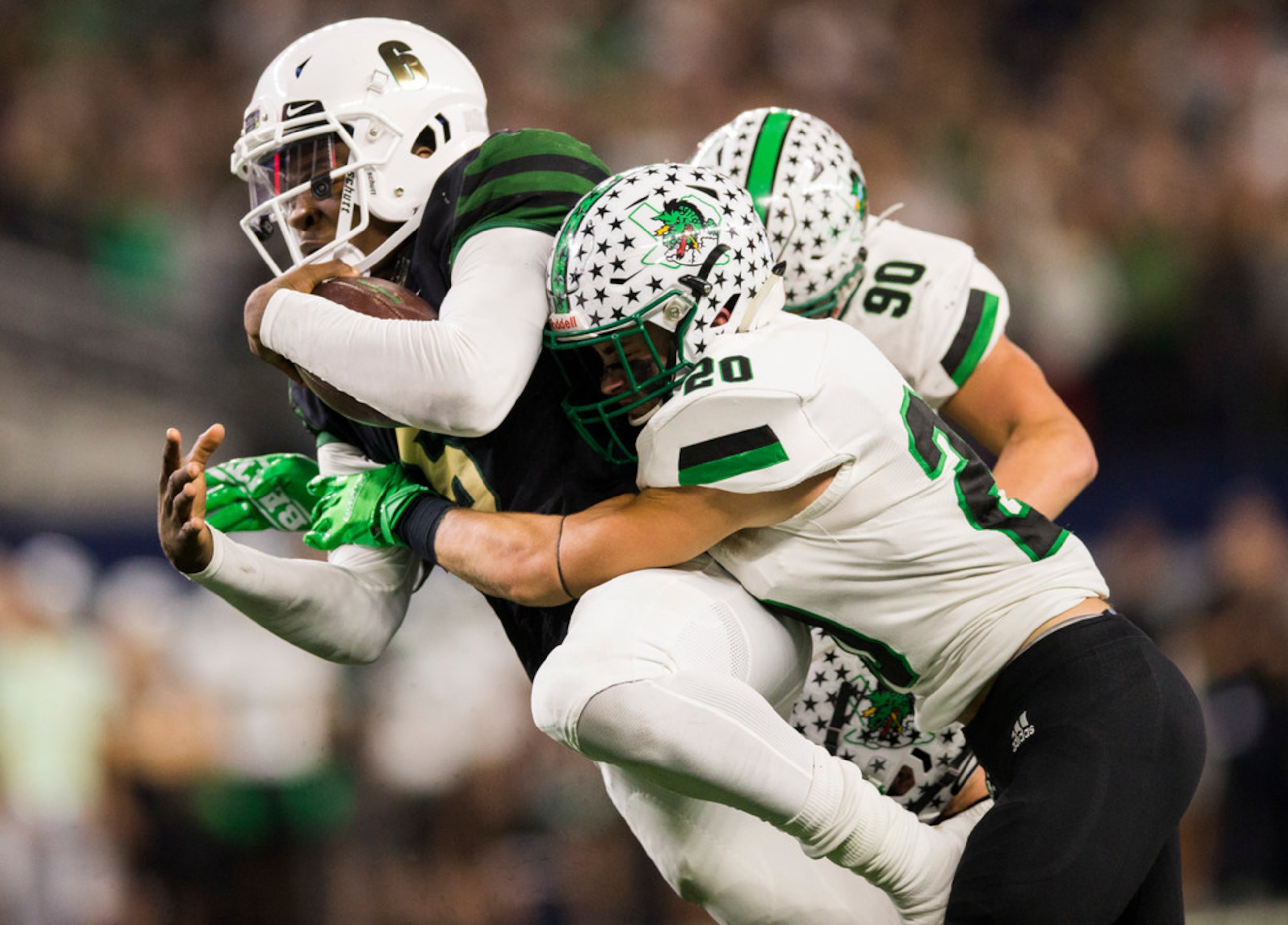 DeSoto quarterback Samari Collier (6) is tackled by Southlake Carroll defensive back James...