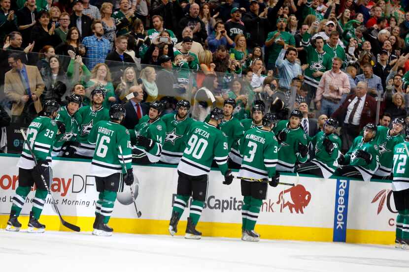 Dallas Stars center Jason Spezza (90) is congratulated by teammates after his first period...