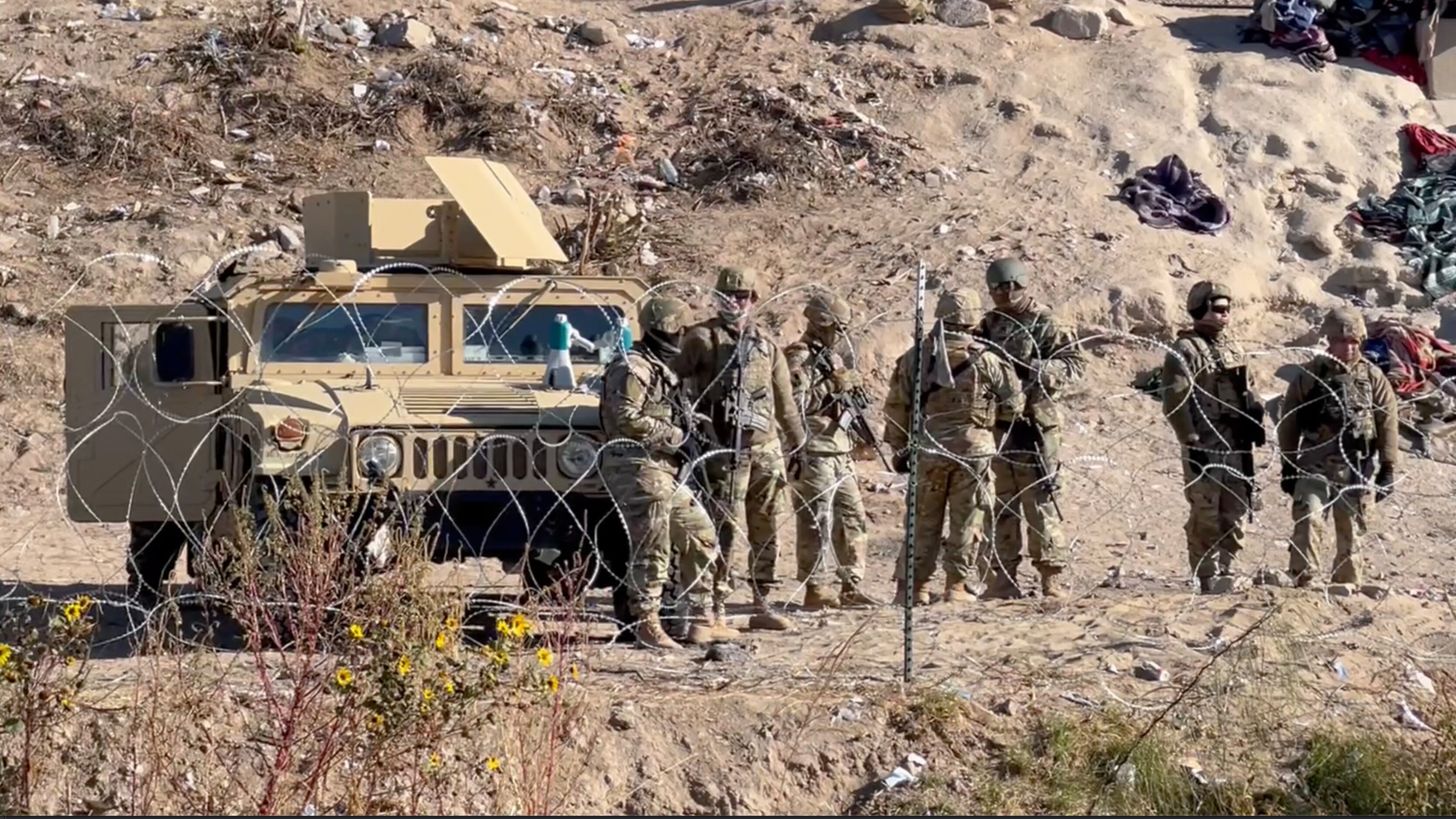 The Texas National Guard gathers along the Rio Grande in El Paso on Tuesday, Dec. 20, 2022,...