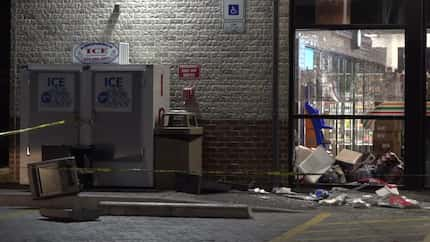 An image from the scene where five masked thieves rammed a pickup into a 7-Eleven and yanked...