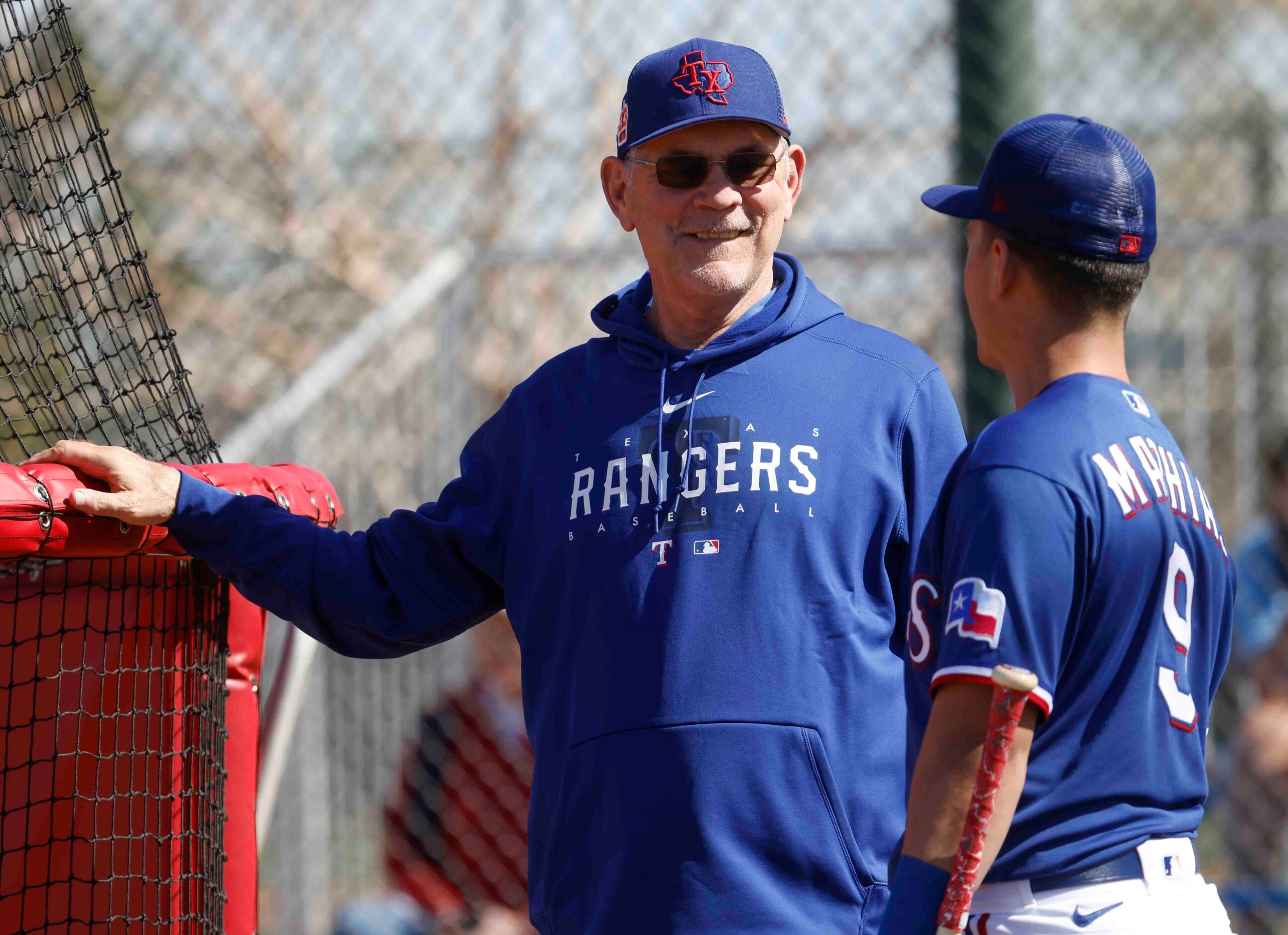 Texas Rangers manager Bruce Bochy, left, talks to infielder Mark Mathias during a spring...