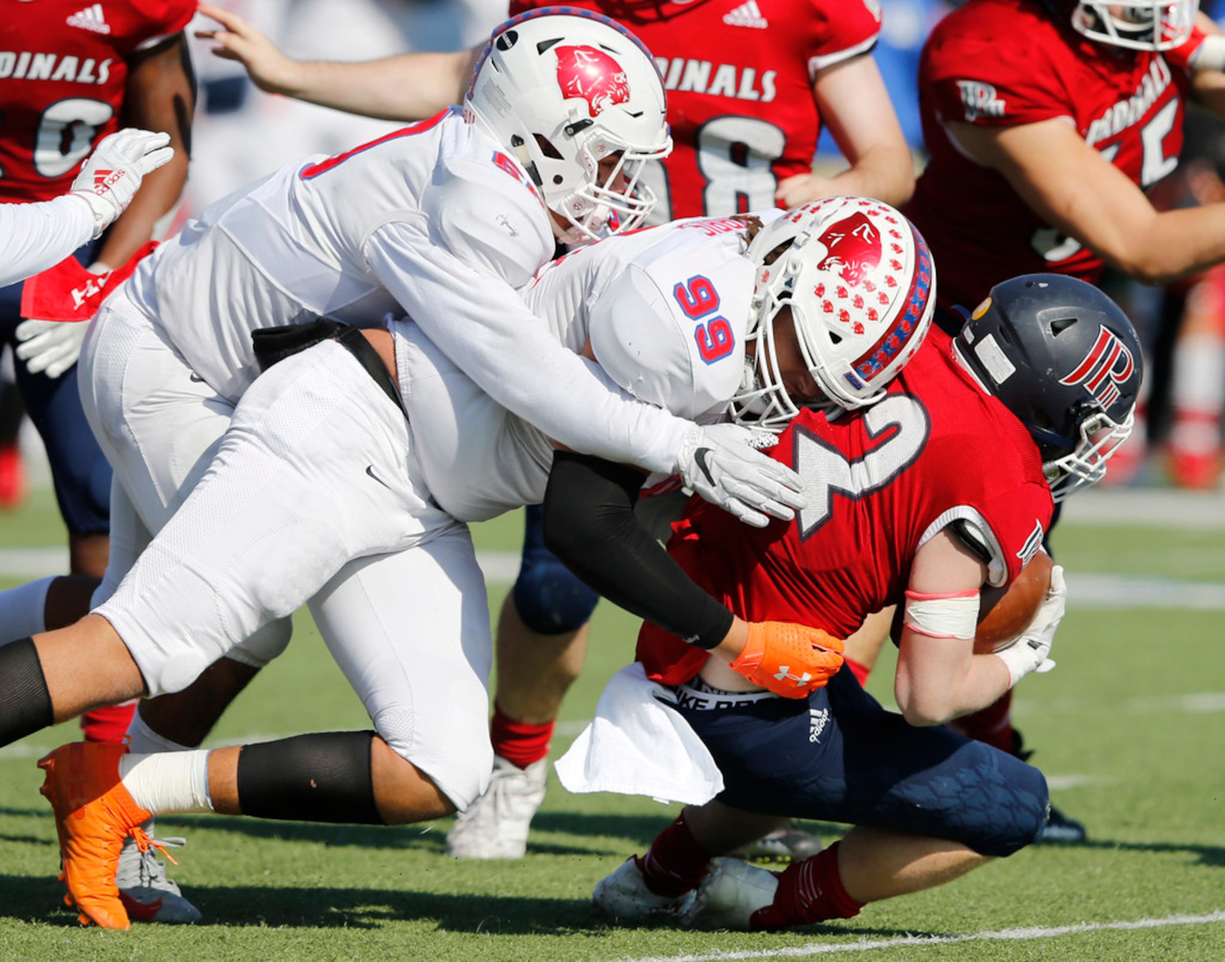 Parish Episcopal's Josue Munoz (60) and Blake Burris (99) tackle Plano John Paul II's John...