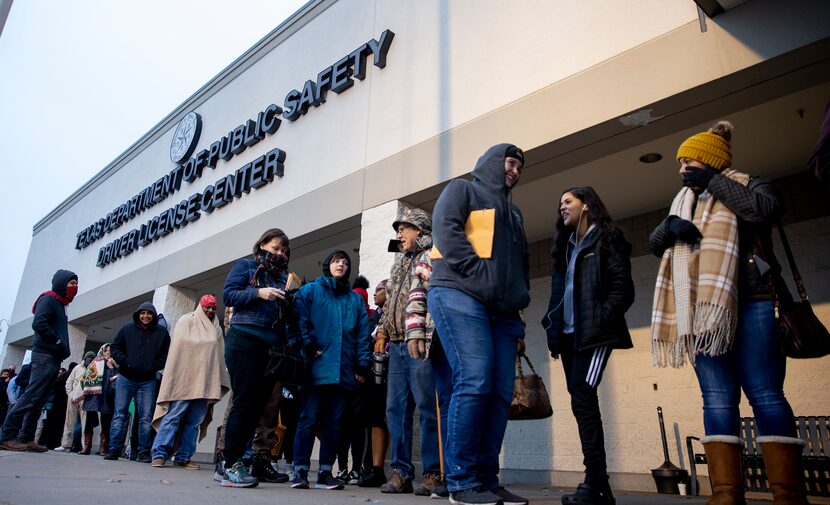 People line up outside the entrance at the Texas Department of Public Safety Driver License...