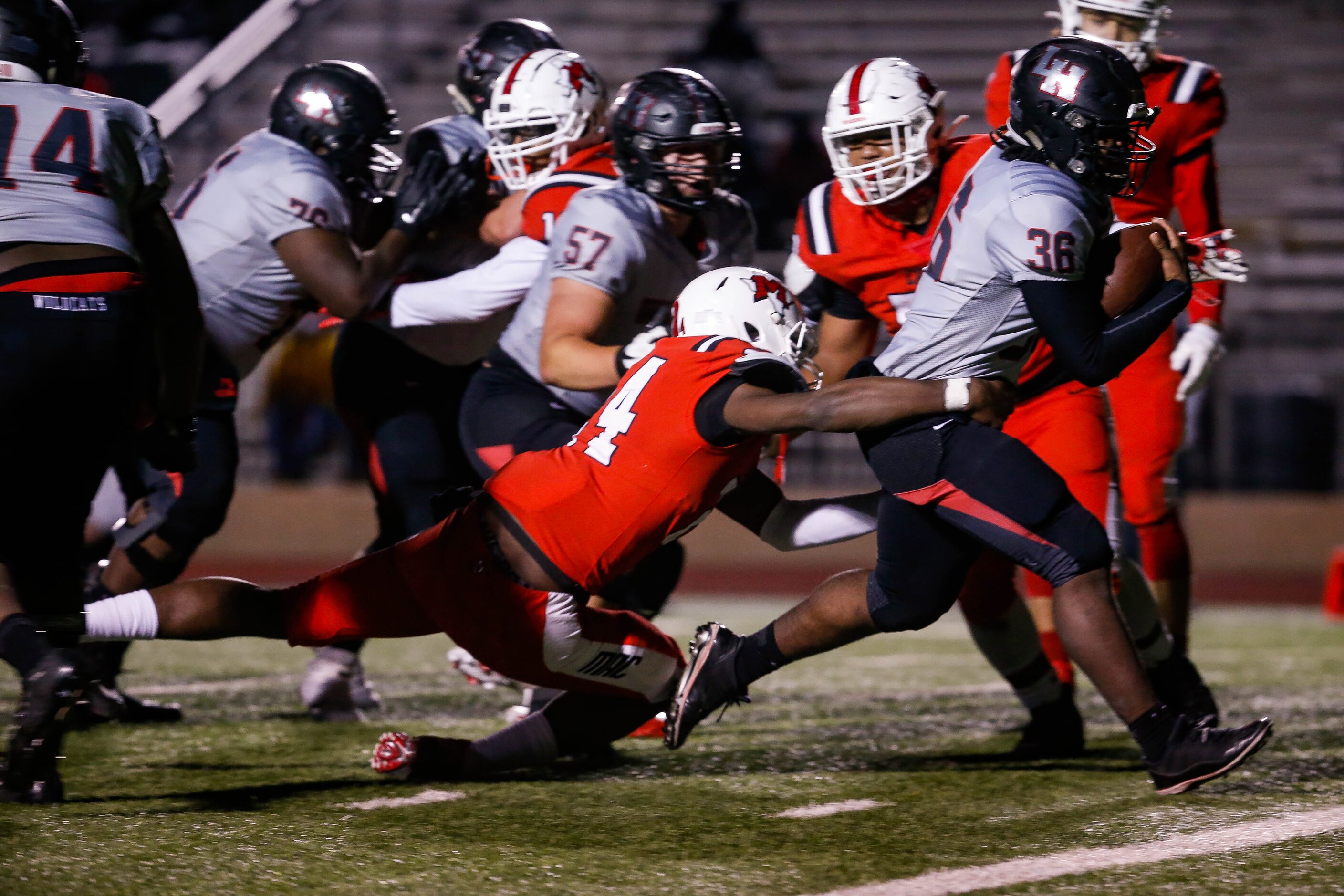 Lake Highlands quarterback Zhmari Edwards (36)evades the Irving MacArthur defense for a...