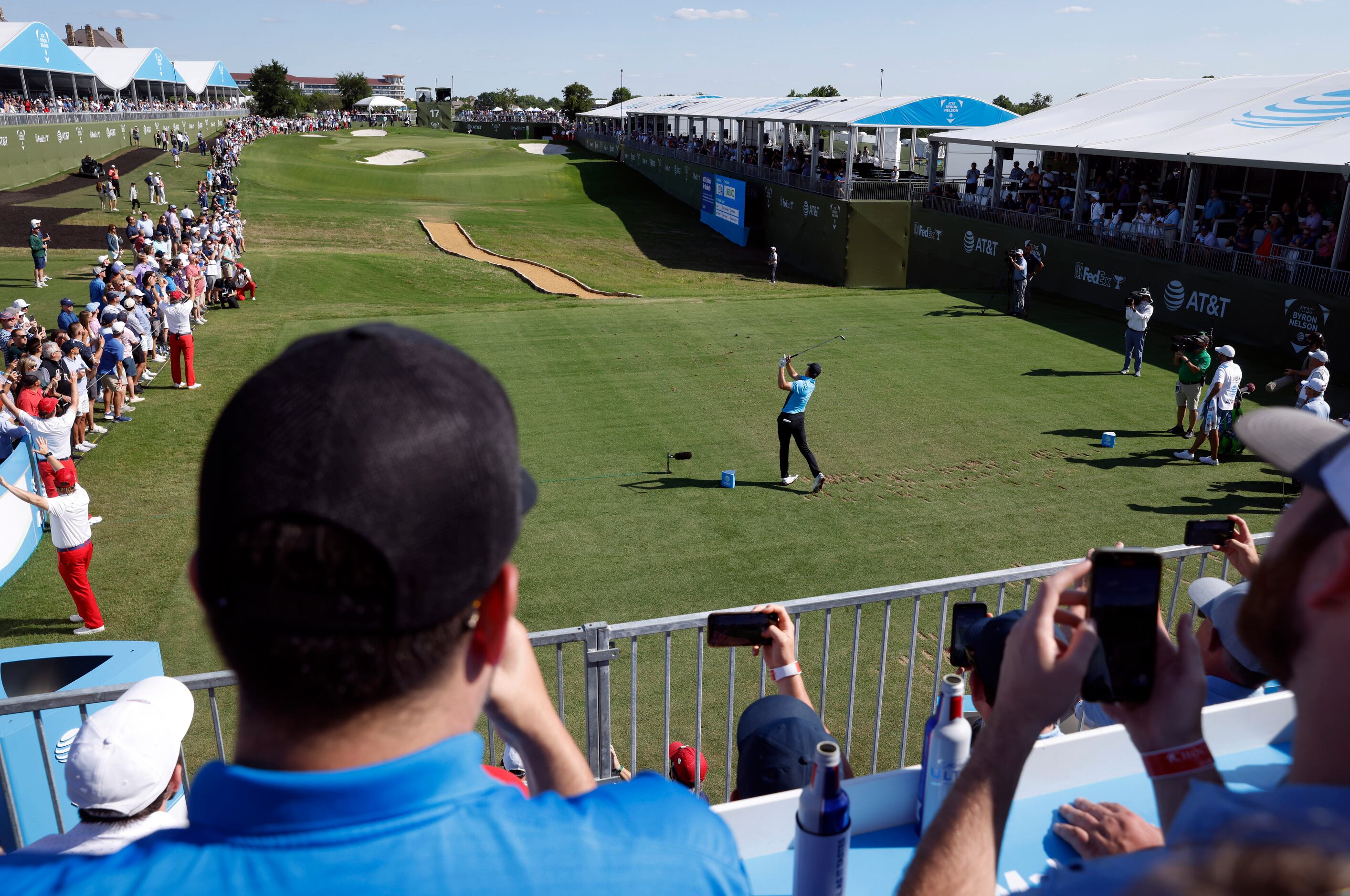 Fans watch as Jordan Spieth tees off on the 17th hole during round 1 of the AT&T Byron...