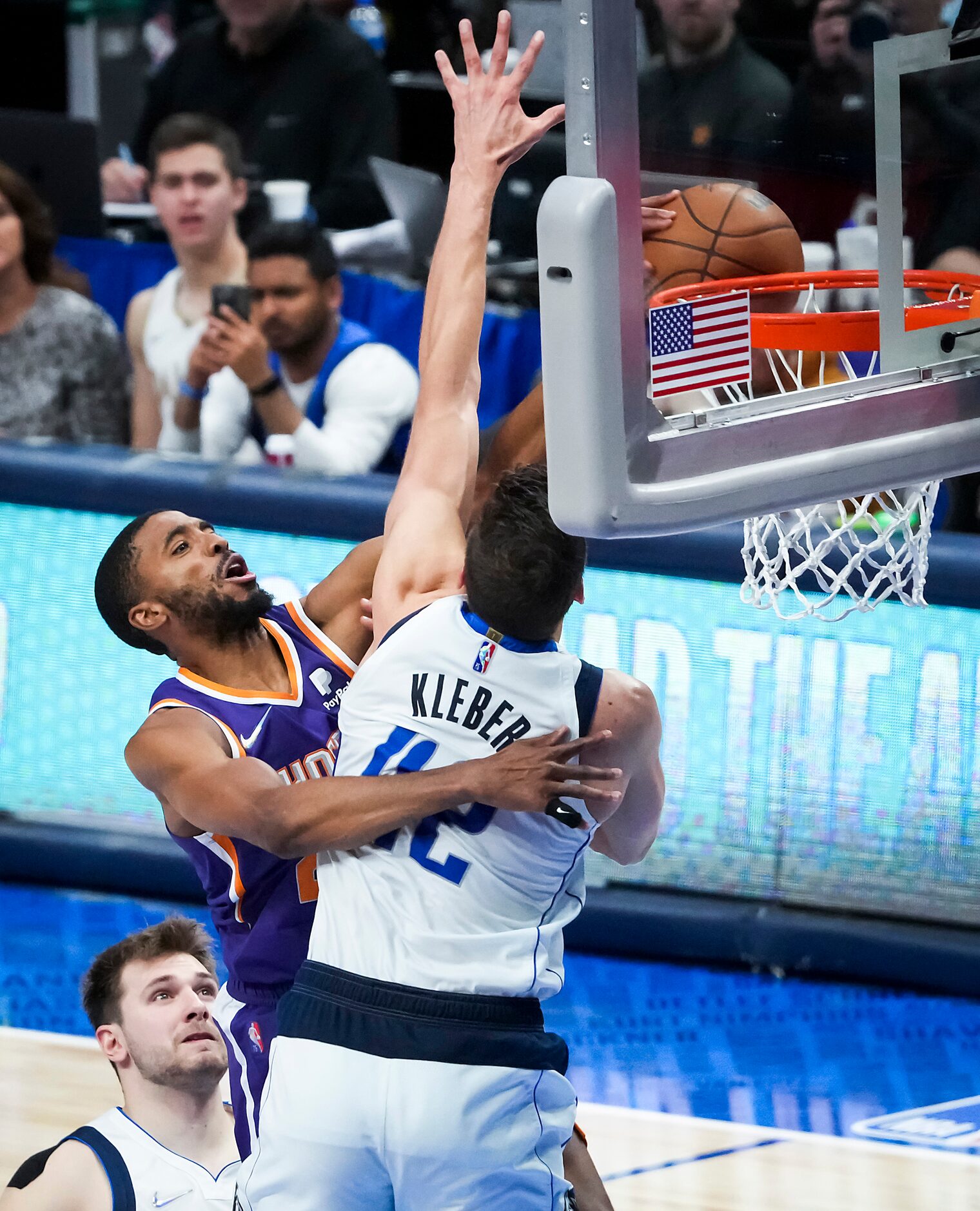 Phoenix Suns forward Mikal Bridges (25) is fouled by Dallas Mavericks forward Maxi Kleber...