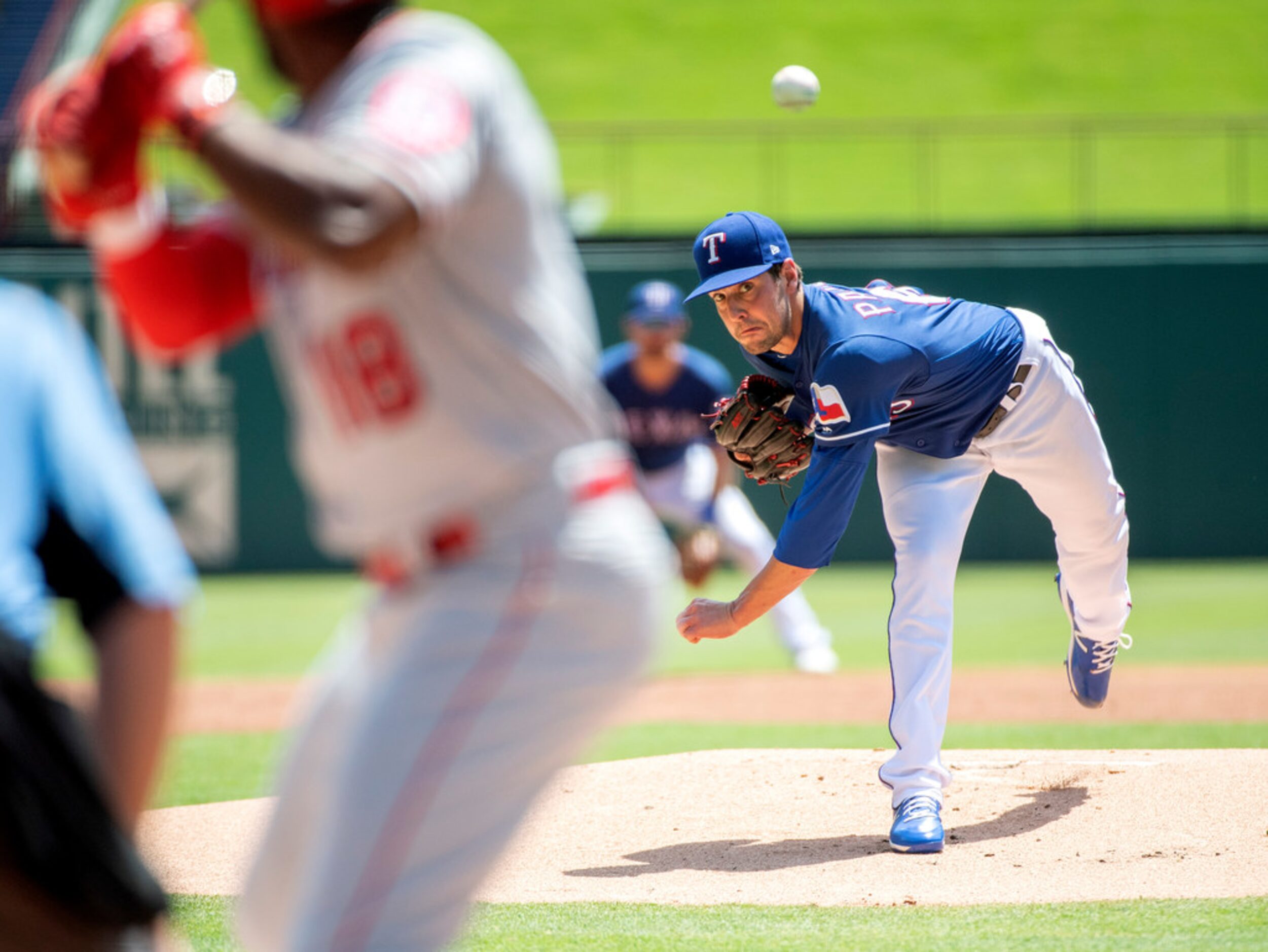 Texas Rangers starting pitcher Joe Palumbo works against Los Angeles Angels' Brian Goodwin...