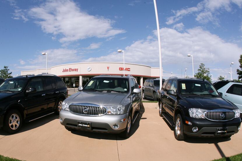 FILE - In this Aug. 27, 2006 file photo, a trio of unsold 2006 Buick Rainier sports utility...