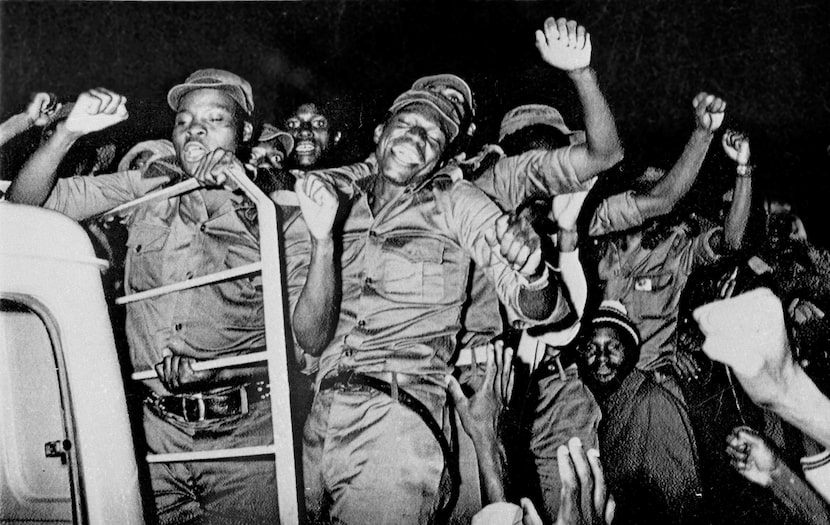 Guerrillas who fought a war for seven years rejoice as they leave the stadium in Zimbabwe's...