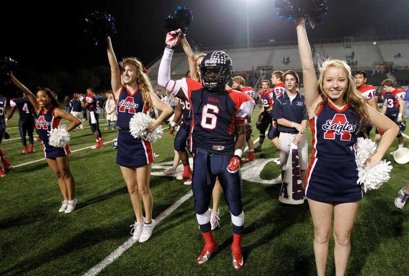 Allen's Kendall Clinton (6) dances with the cheerleaders after they defeated Skyline in the...