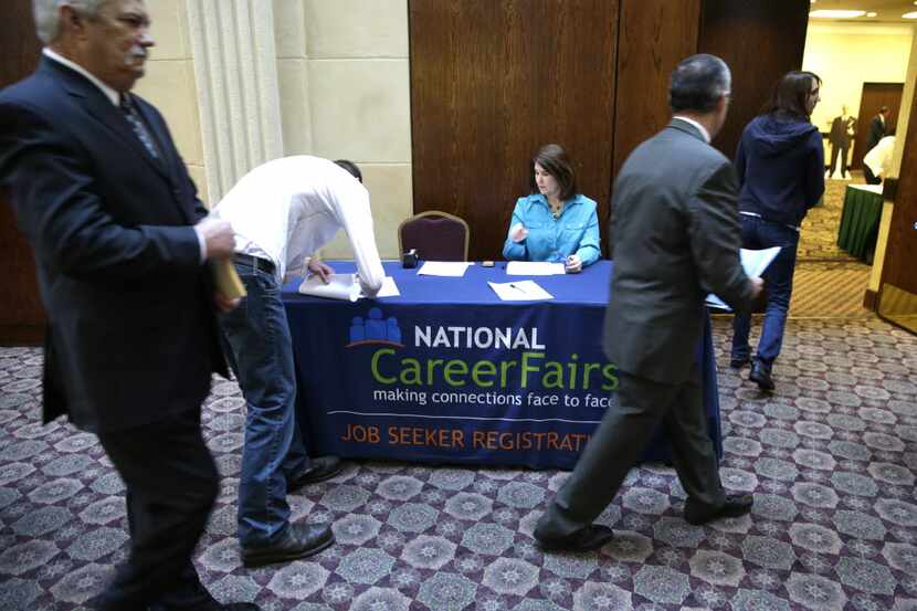 In this Wednesday, Jan. 22, 2014, photo, job seekers arrive to meet prospective employers...