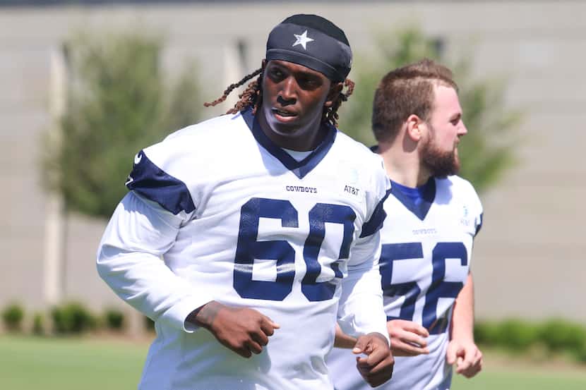 Dallas Cowboys offensive line Tyler Guyton (60) exits the field following a rookie minicamp,...