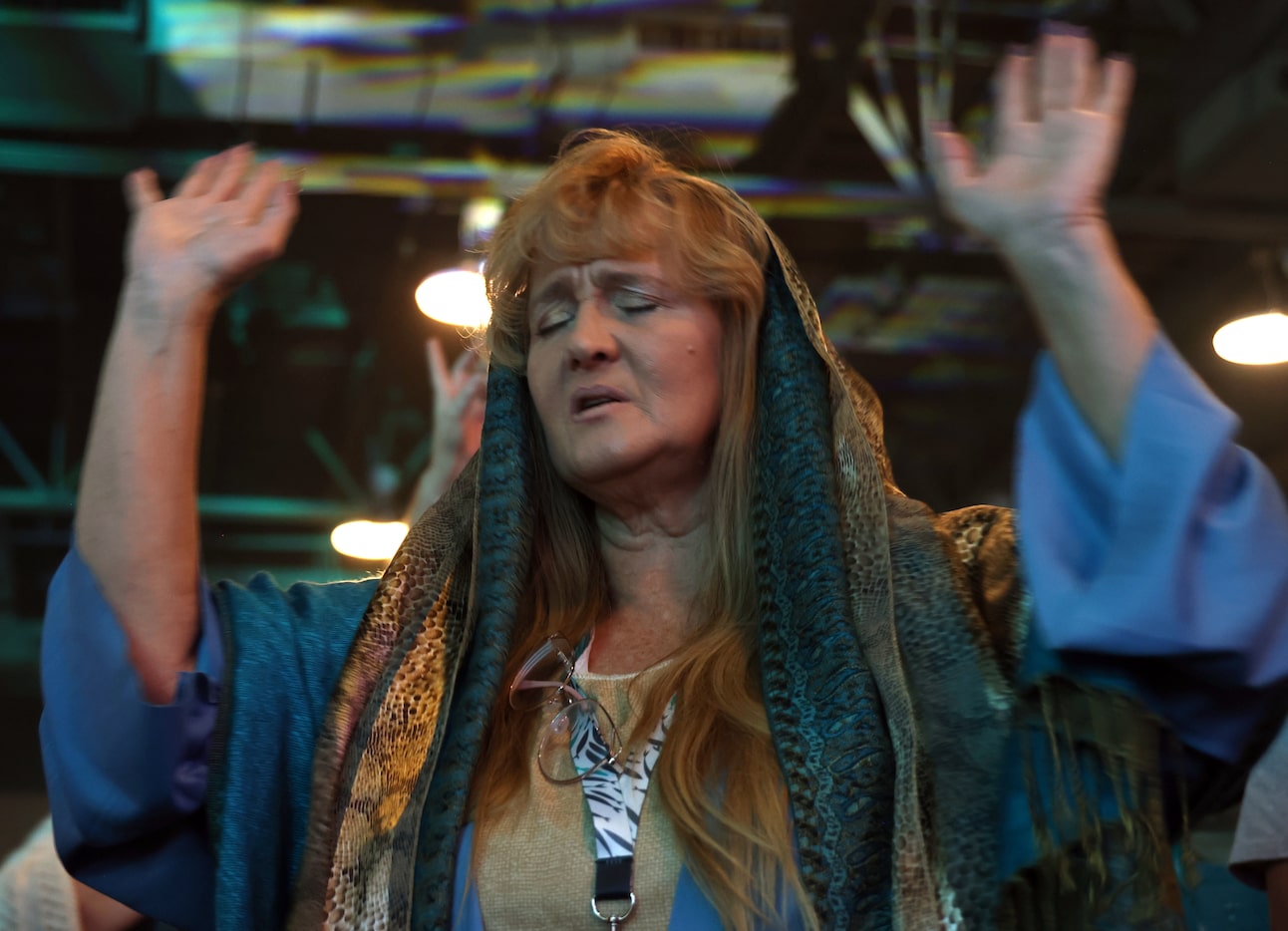 Adorning the first century costume of Mary Magdalene, Tracy Mehne, of Rowlett, raises her...