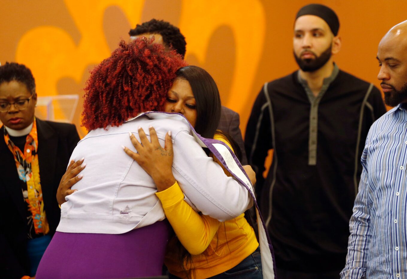 Dr. Irie Session (left) of Dallas hugs L'Daijohnique Lee (right) during a press conference...