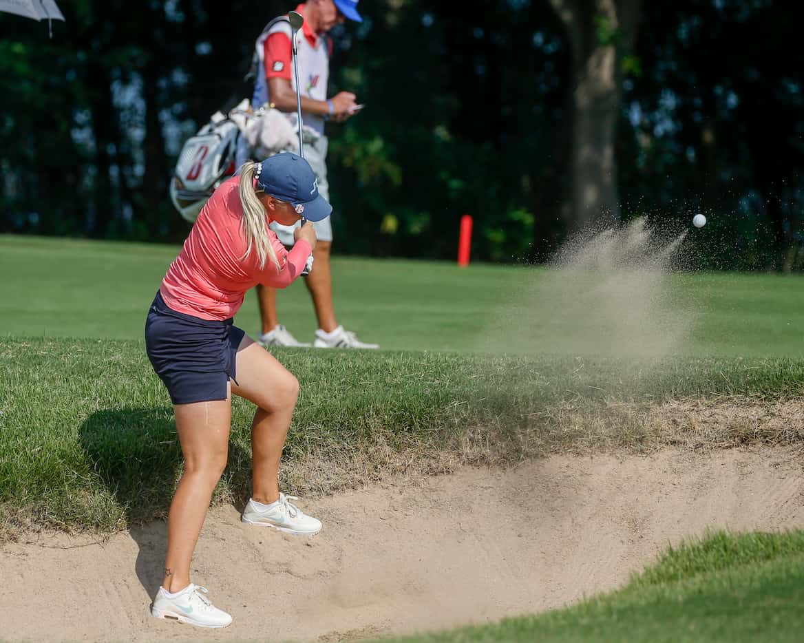 Professional golfer Matilda Castren plays out of the No. 13 fairway side bunker during the...