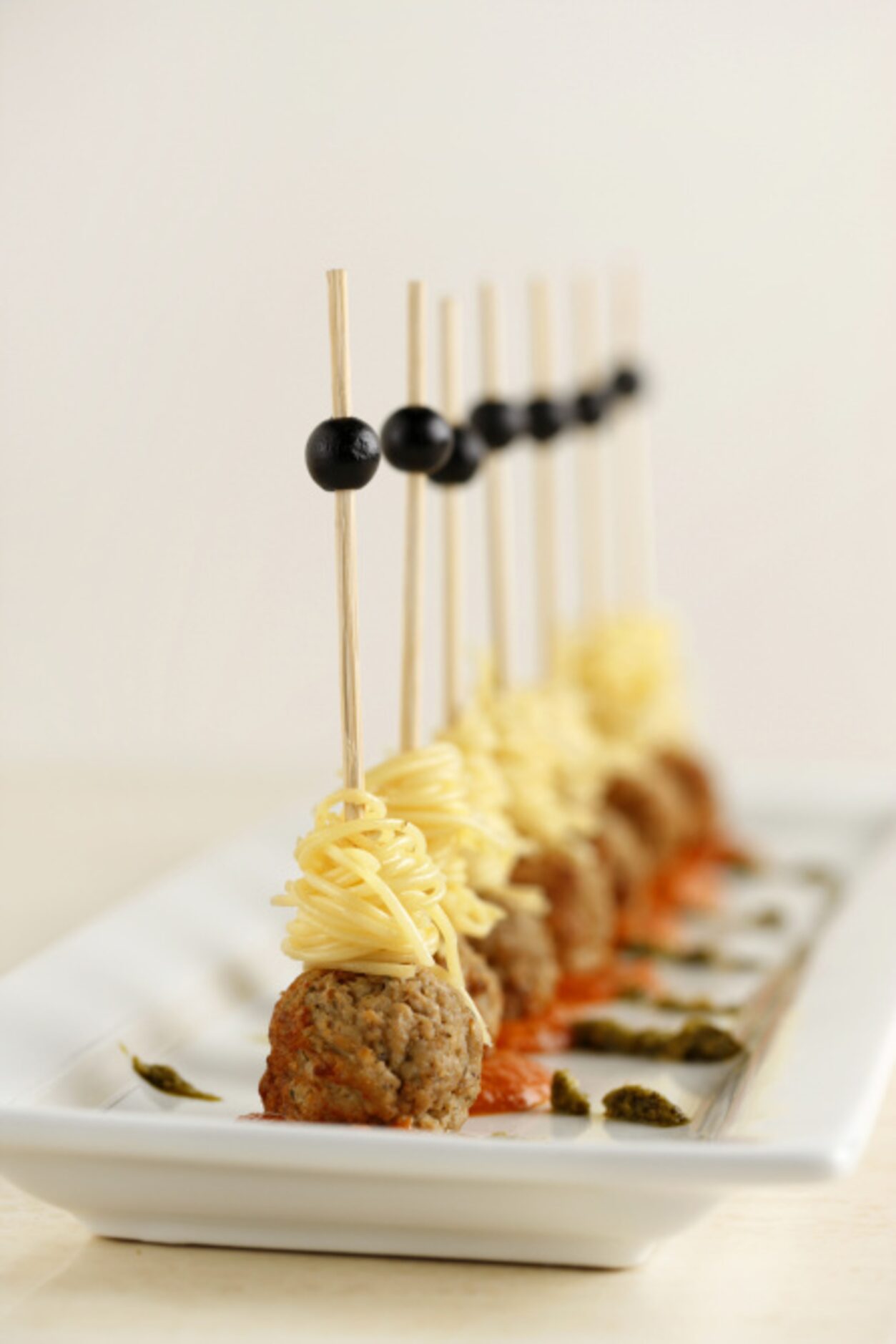 SPAGHETTI AND MEATBALLS: Twirl cooked angel hair pasta around a skewer, then add a cooked...