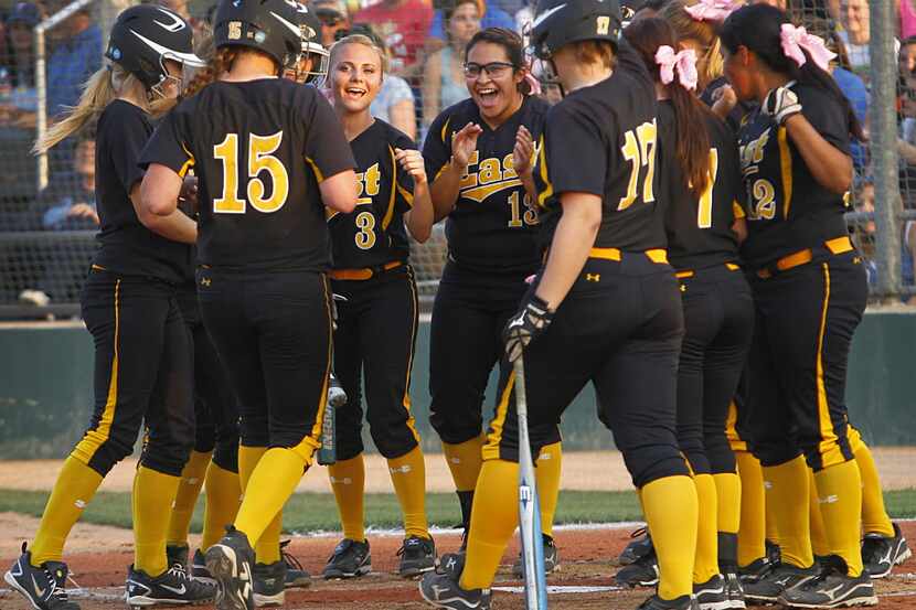 Plano East's Holly Kern (15) is welcomed home after he three run homer in the first innng...