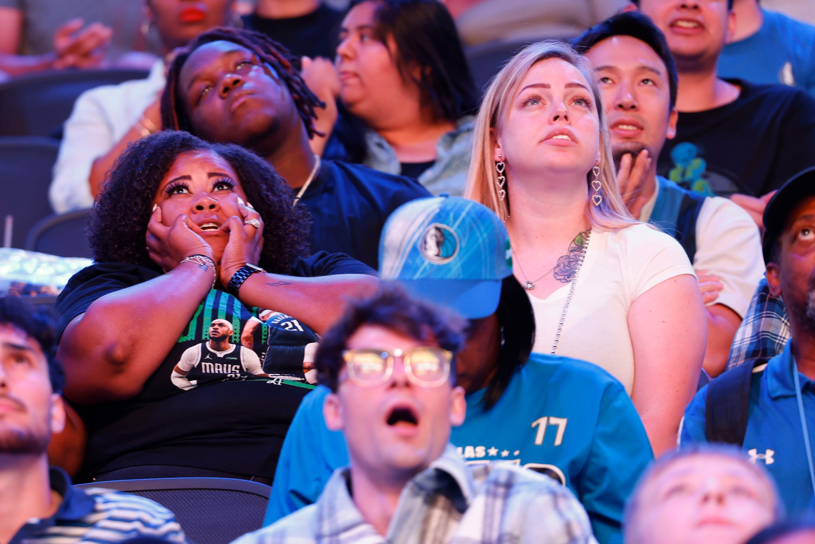 Dallas Mavericks fans look dejected following a three-pointer by Boston Celtics during a...