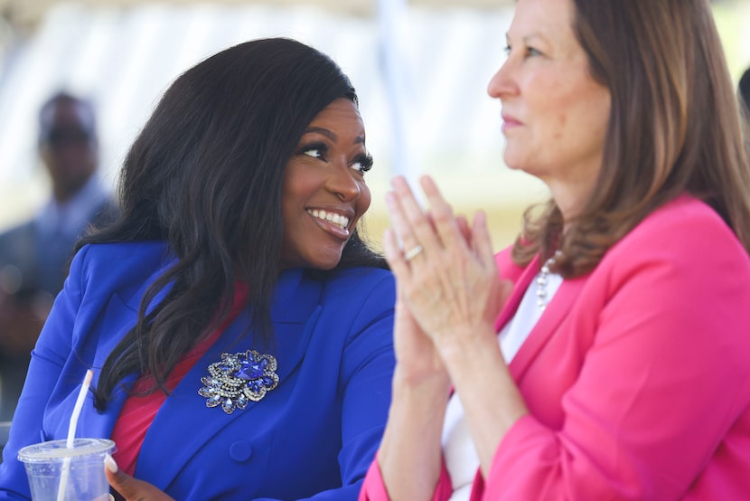 Rep. Jasmine Crockett, D-Texas, left, cheers during an event presenting a check for $2.5...