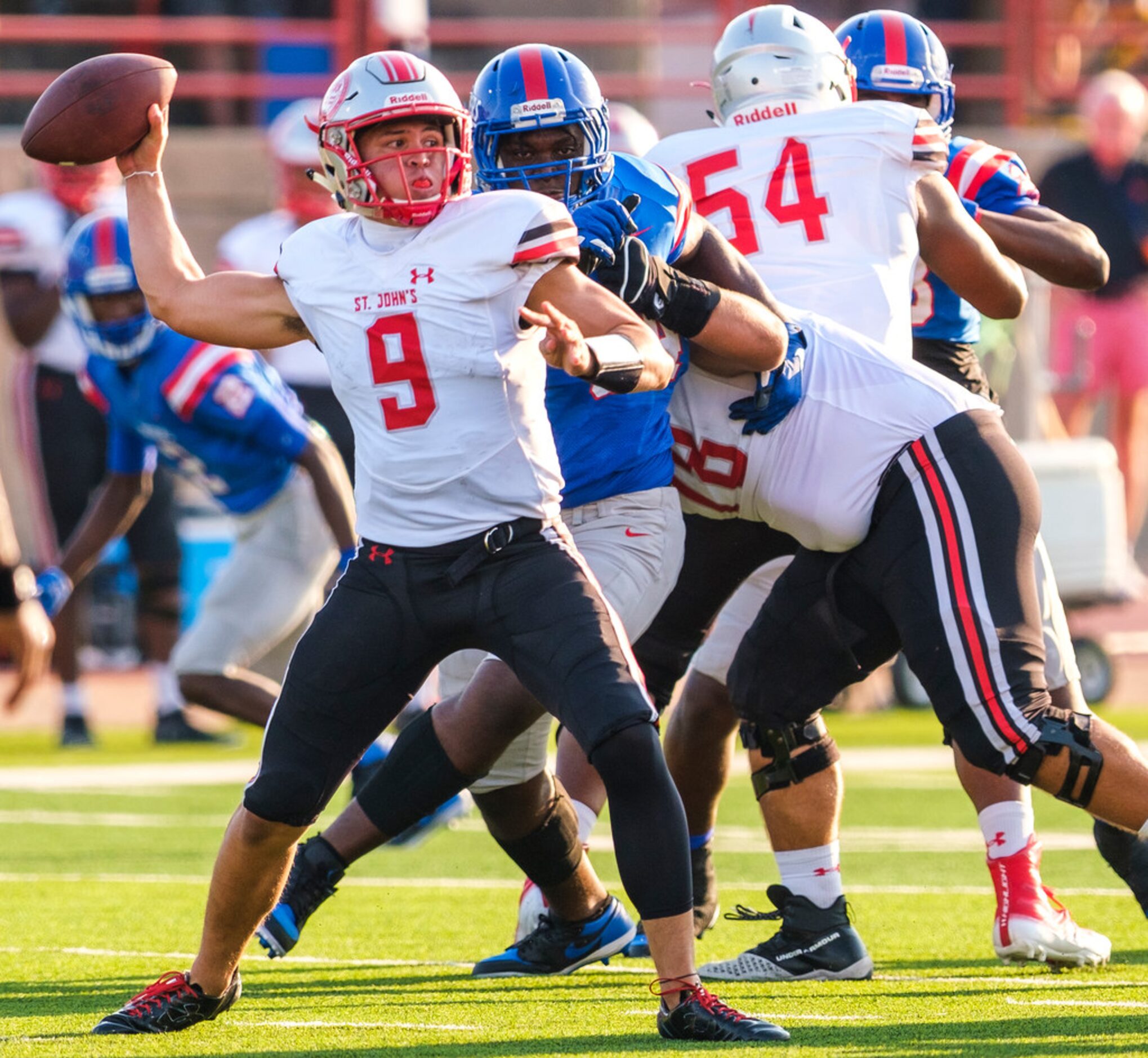 St. John's College (D.C.) quarterback Sol-Jay Maiava (9) throws a pass under pressure from...