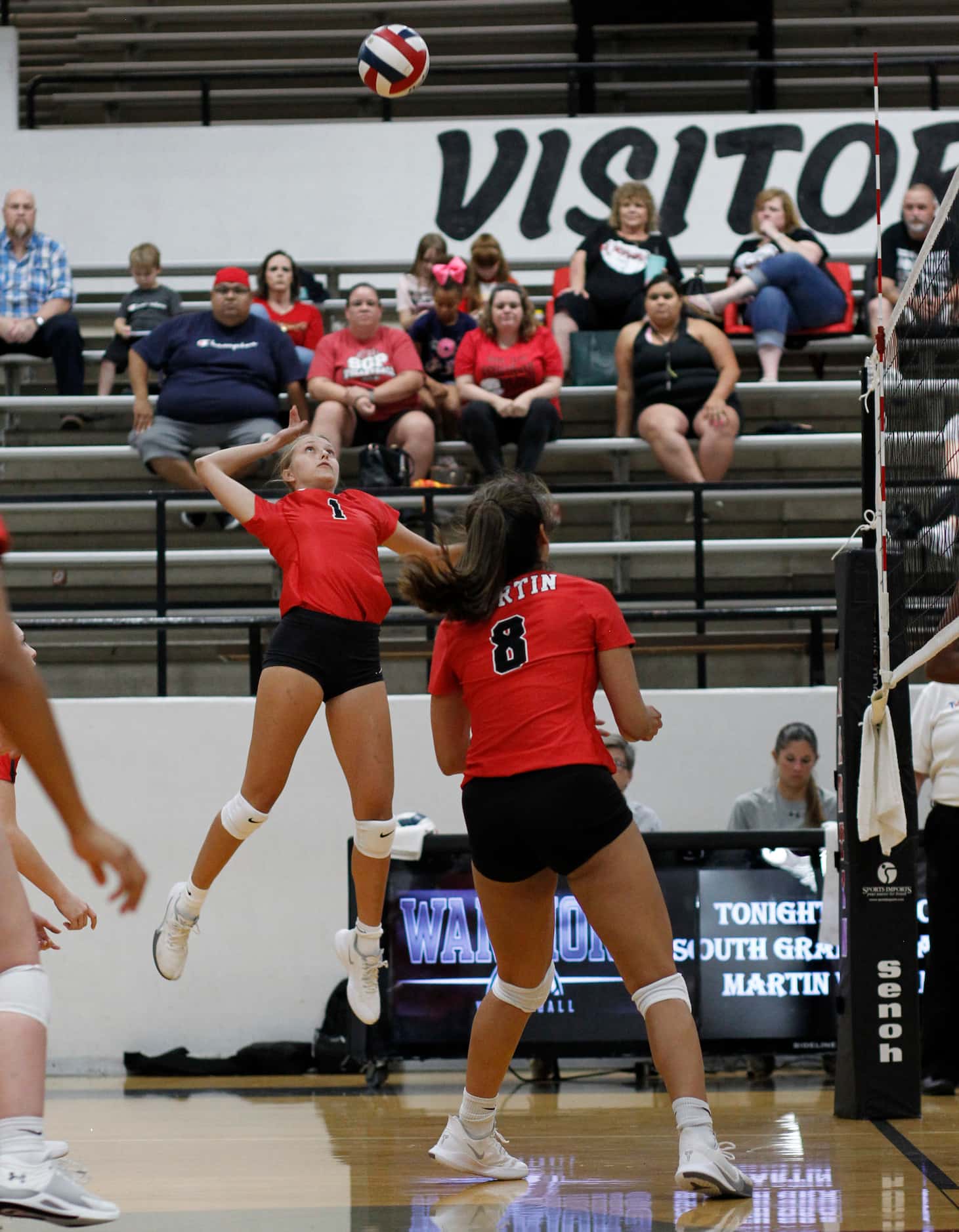 Arlington Martin's Desiree Reinwand (1) skies as she prepares to deliver a spike during the...