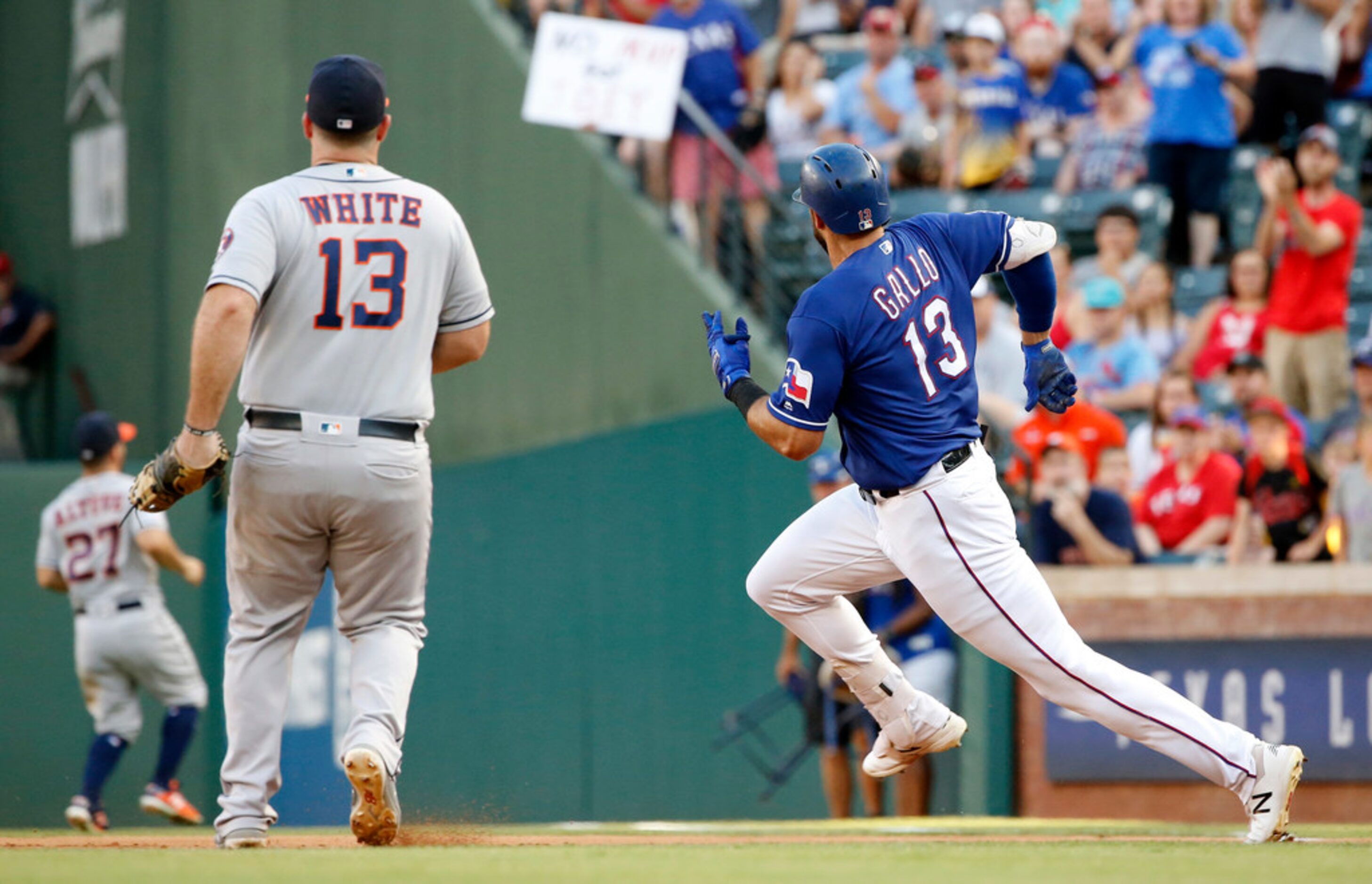 Texas Rangers batter Joey Gallo (13) races to second on a first inning double against the...