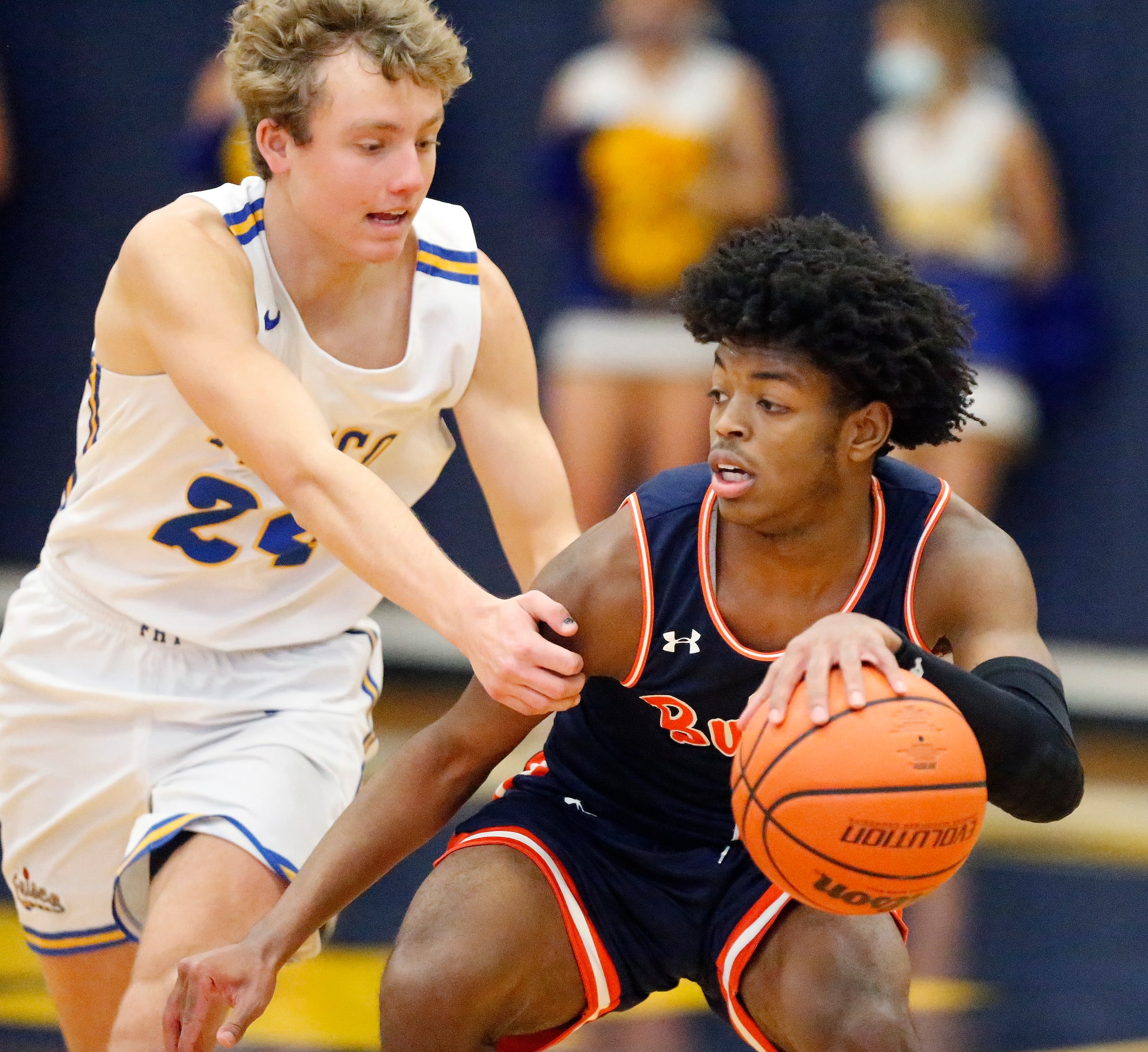 Frisco High School forward Rocco Paul (24) fouls McKinney North High School guard J.J. Henry...