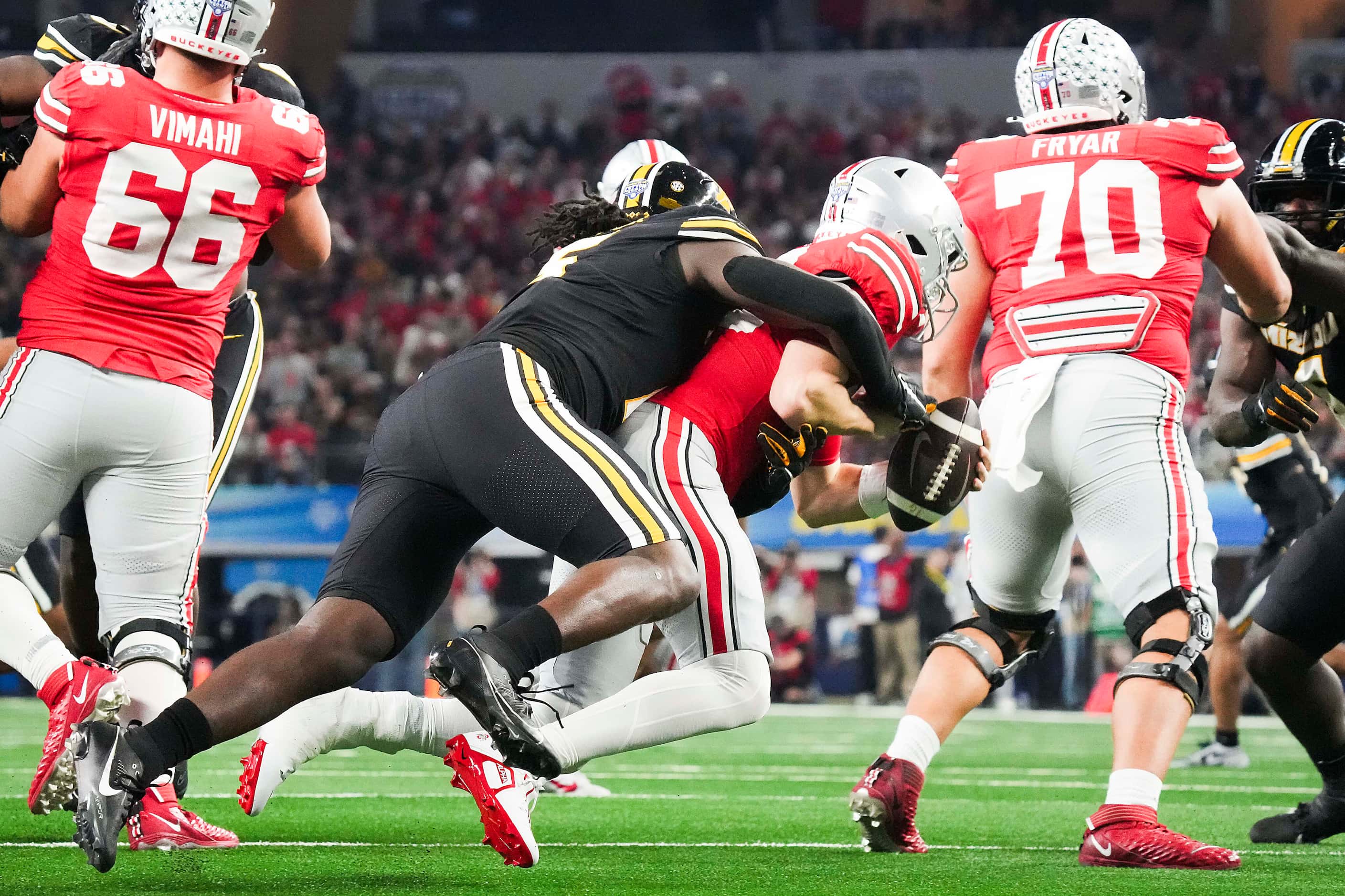 Ohio State quarterback Devin Brown (33) is sacked by Missouri defensive lineman Johnny...