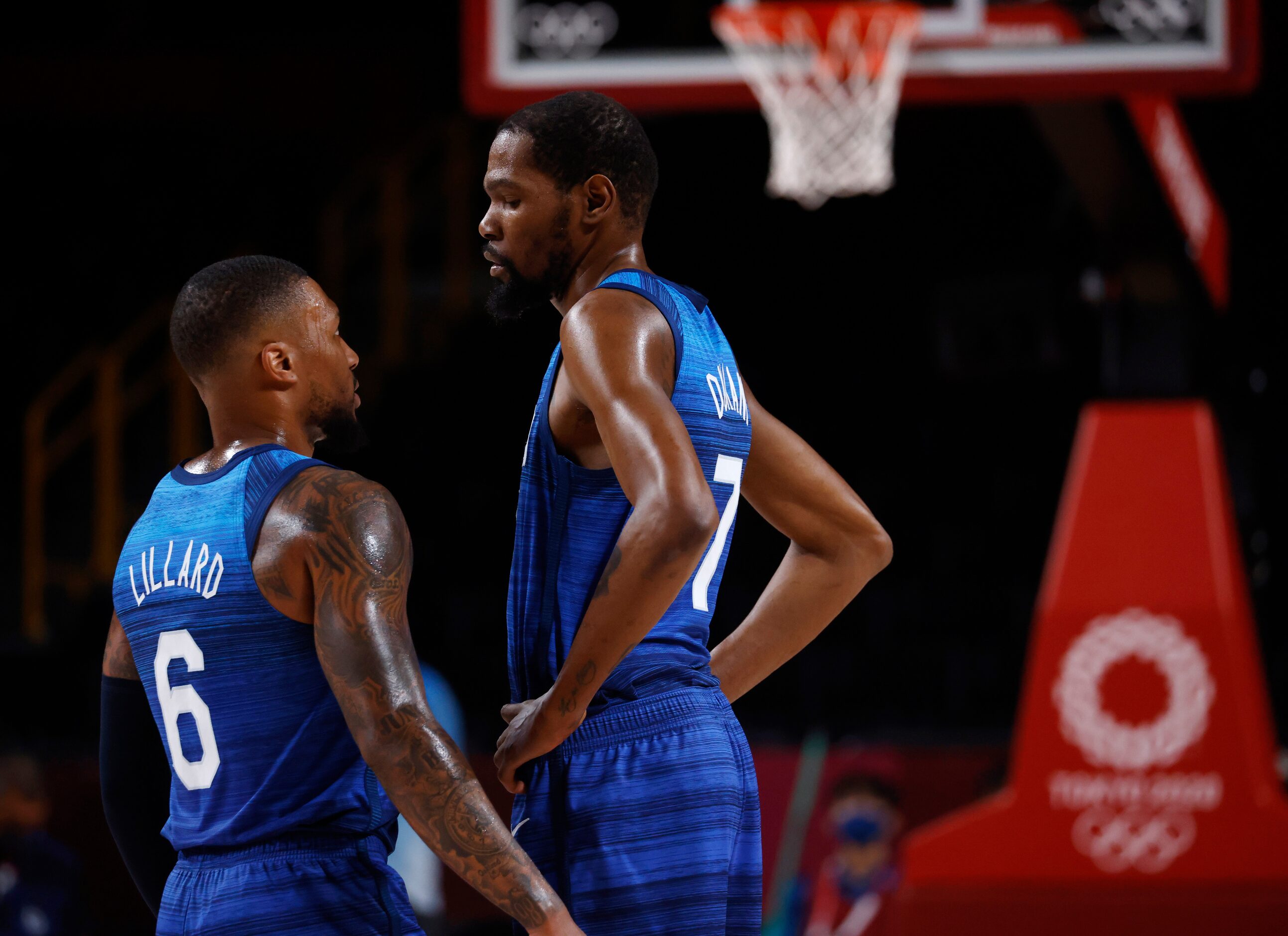 USA’s Damian Lillard (6) talks with Kevin Durant (7) during a break in play against Spain in...