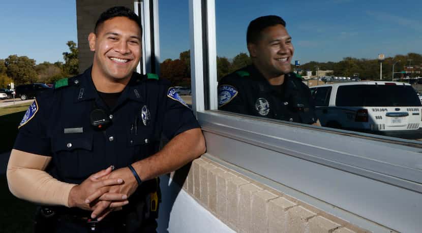 Euless Police officer Eric Fieilo poses for a portrait at Euless High School on Monday,...