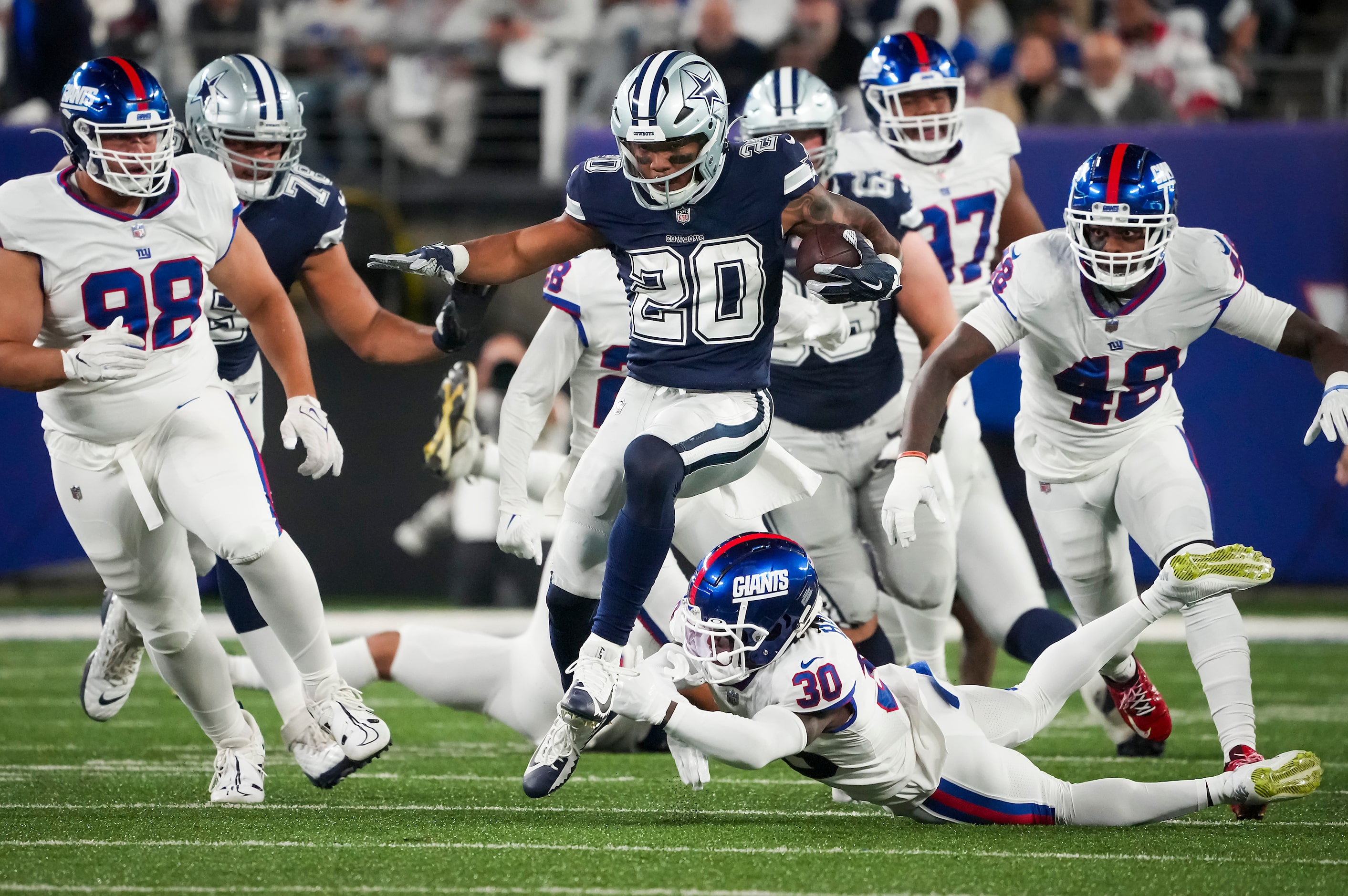 Dallas Cowboys running back Tony Pollard (20) gets past New York Giants cornerback Darnay...