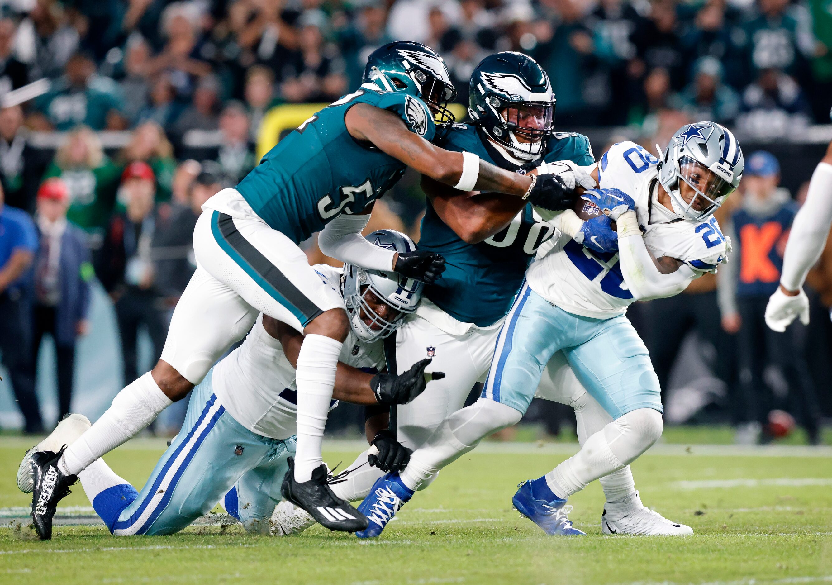 Dallas Cowboys running back Tony Pollard (20) tries to elude the grasp of Philadelphia...