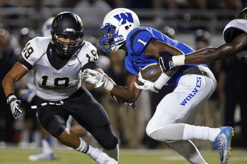 Plano West running back Sotonye Jamabo (1) carried for a big gain before being caught by...