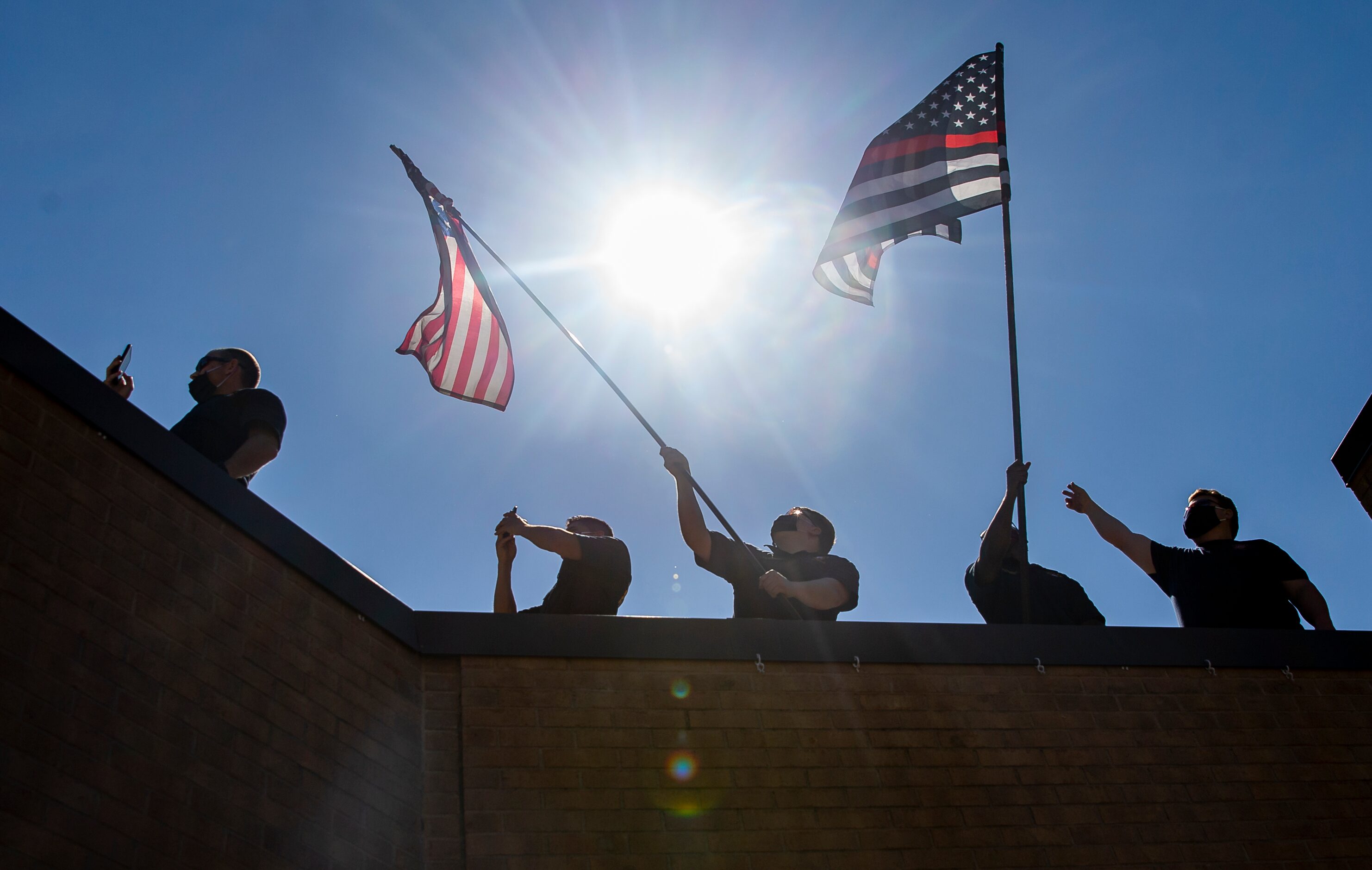 Dallas Fire-Rescue first responders at Fire Station 18 watch as the U.S. Navy Blue Angels...