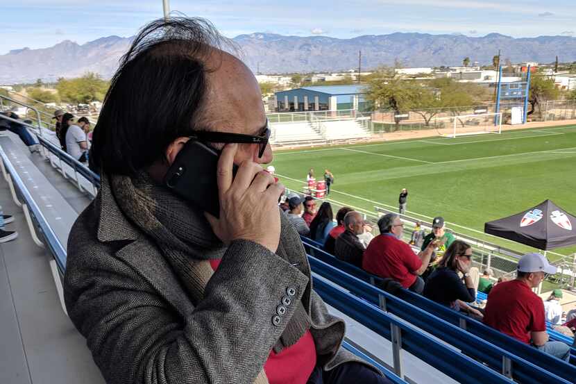 FC Dallas technical director Fernando Clavijo works the phone while watching FC Dallas play...