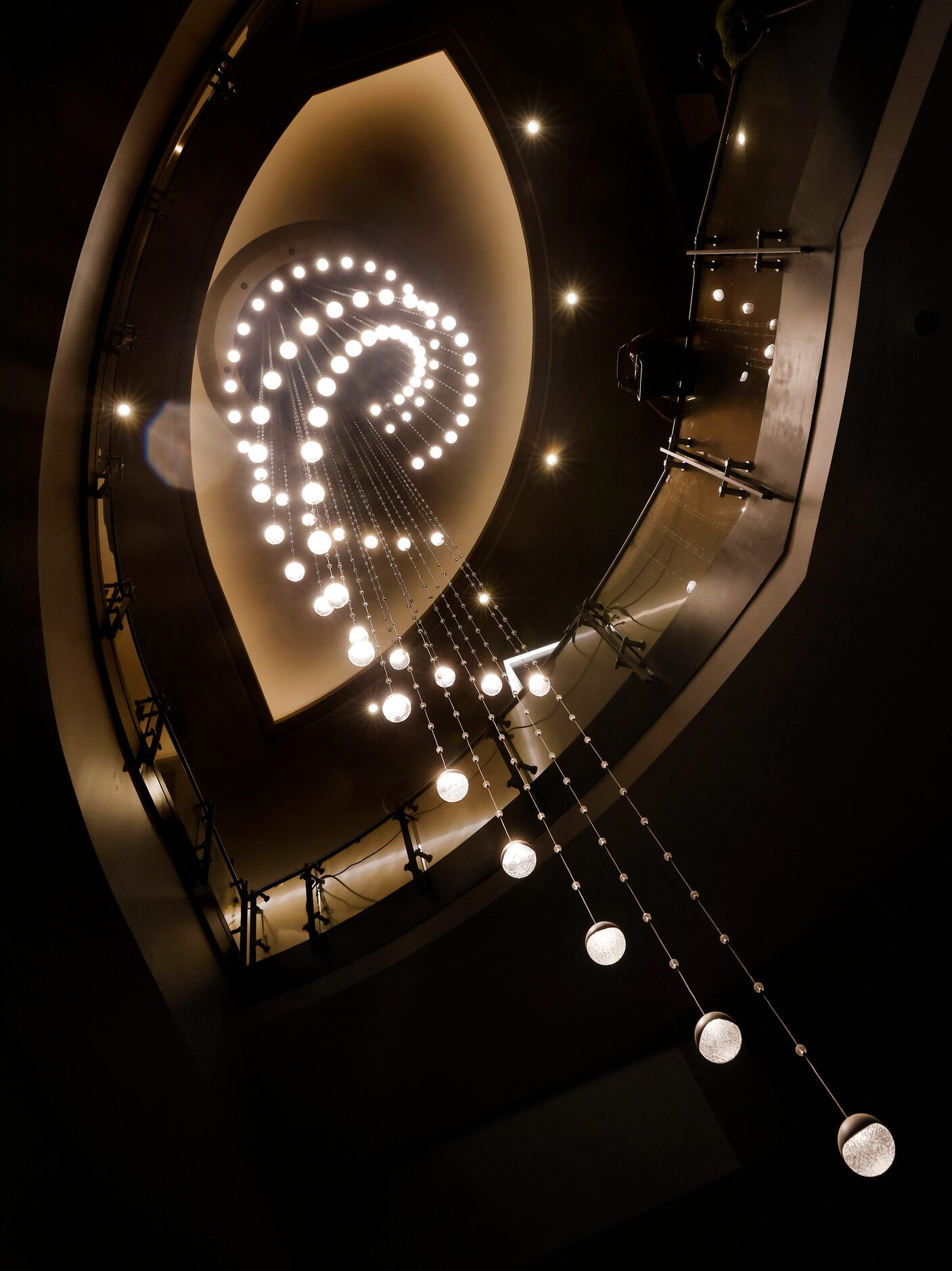 A three-story circular light fixture hangs alongside the grand staircase in the Sky Tower...