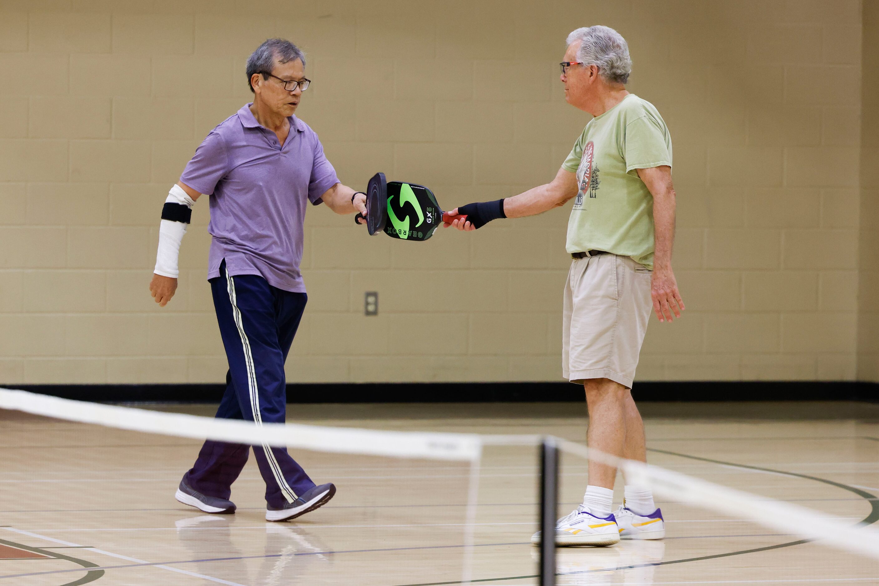 Tet Wu (left) of Plano, cheers with Toug Hao during a pickle ball game on Friday, May 26,...