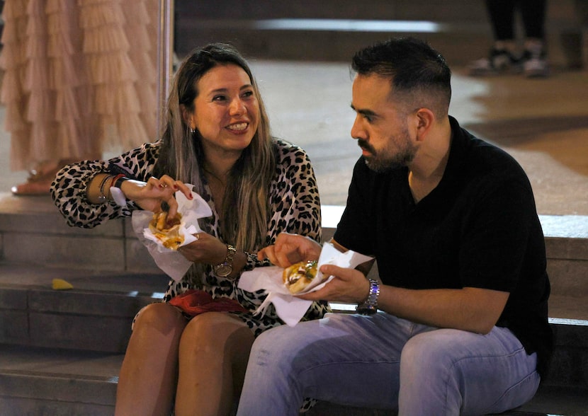 Adriana Lopez and her husband Diego Lopez have Mexican hot dogs in front of the American...