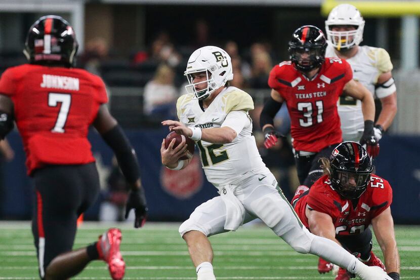 Baylor Bears quarterback Charlie Brewer (12) makes a break with the ball during the first...