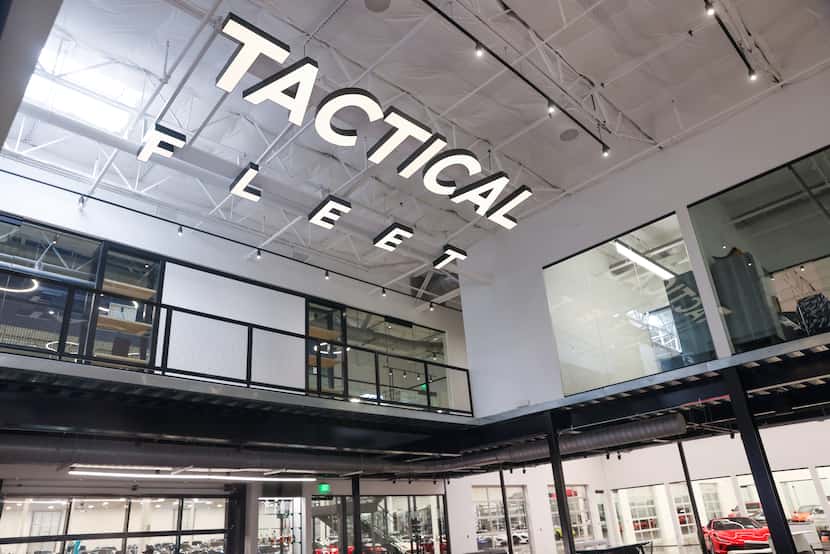 Tactical Fleet's upstairs industrial-chic office overlooks an expanse of expensive cars.