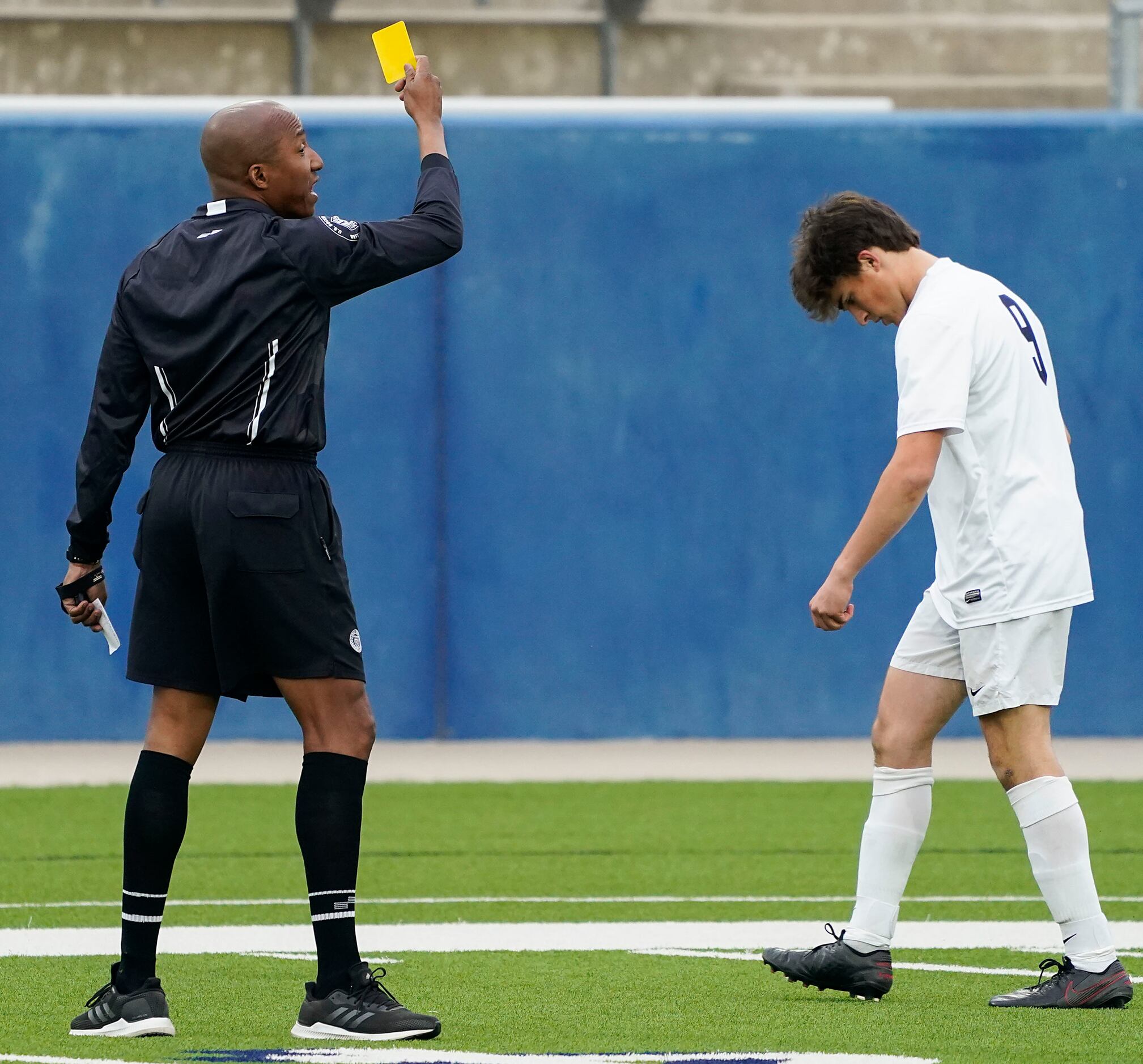 Jesuit midfielder Grant Koshakji heads to the bench as he is issued a yellow card during a...