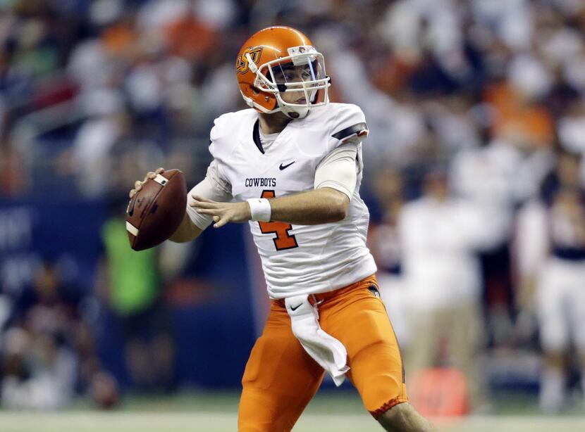 Oklahoma State's J.W. Walsh (4) looks to throw against Texas San Antonio during the first...