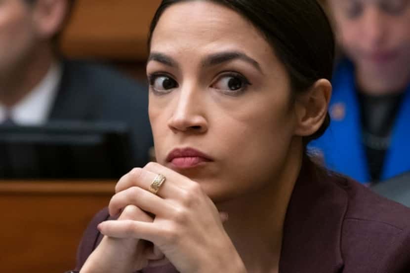 Rep. Alexandria Ocasio-Cortez, D-N.Y., listens to questioning of Michael Cohen, President...