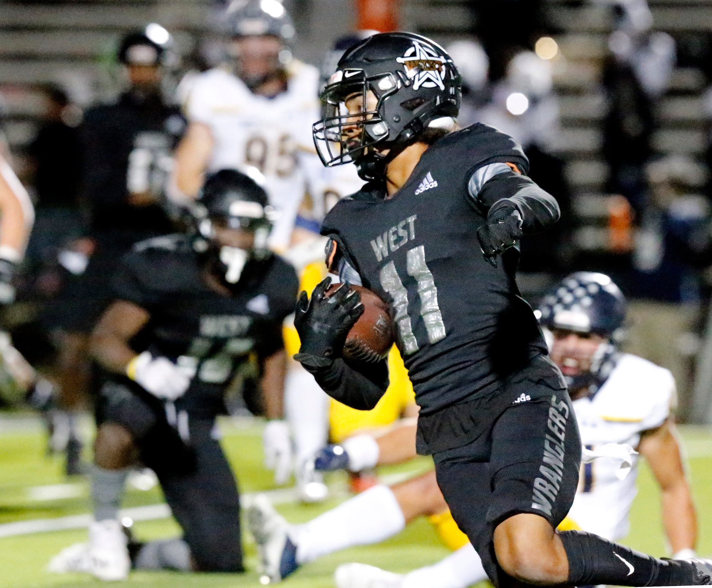 West Mesquite High School wide receiver Gabriel Corona (11) carries the football on a...