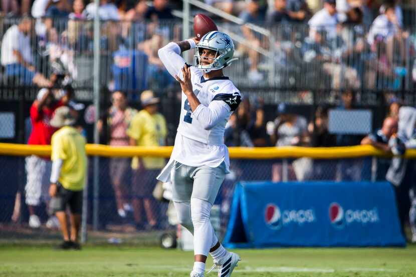 Dallas Cowboys quarterback Dak Prescott (4) throws a pass during an afternoon practice at...