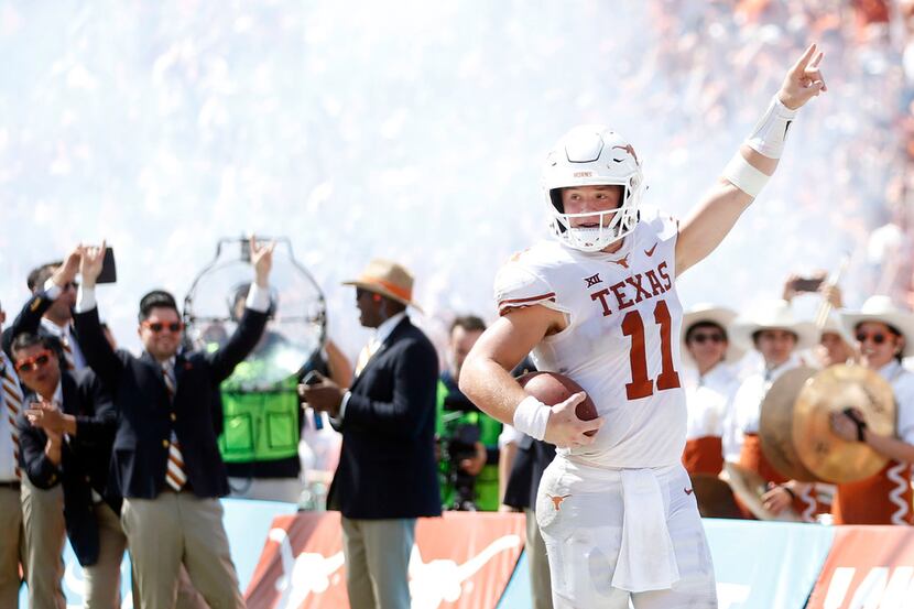 FILE - Texas quarterback Sam Ehlinger (11) celebrates a touchdown during the second half of...