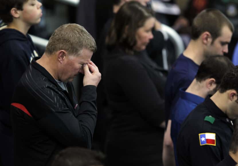A man gets emotional during a prayer at a memorial service for Chris Kyle at Cowboys Stadium...