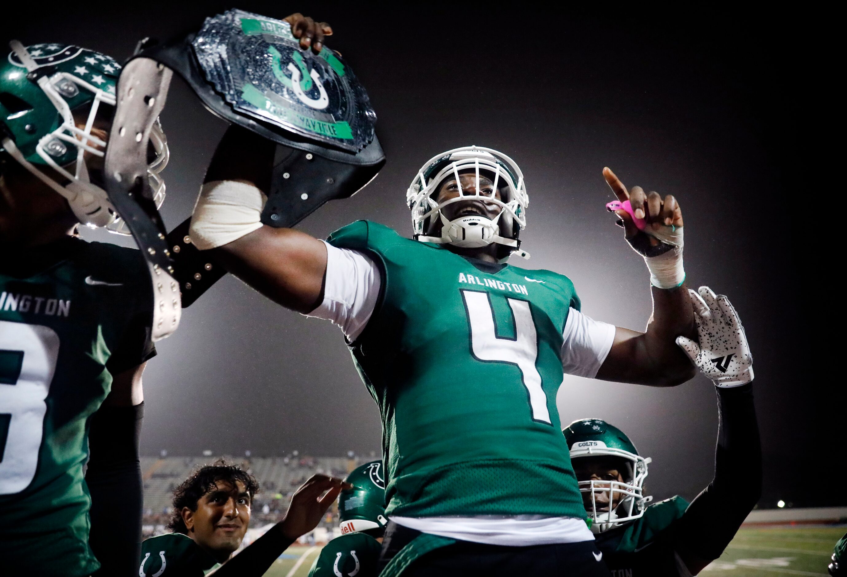 Arlington High linebacker Caleb Olabode (4) celebrates his fourth quarter turnover against...