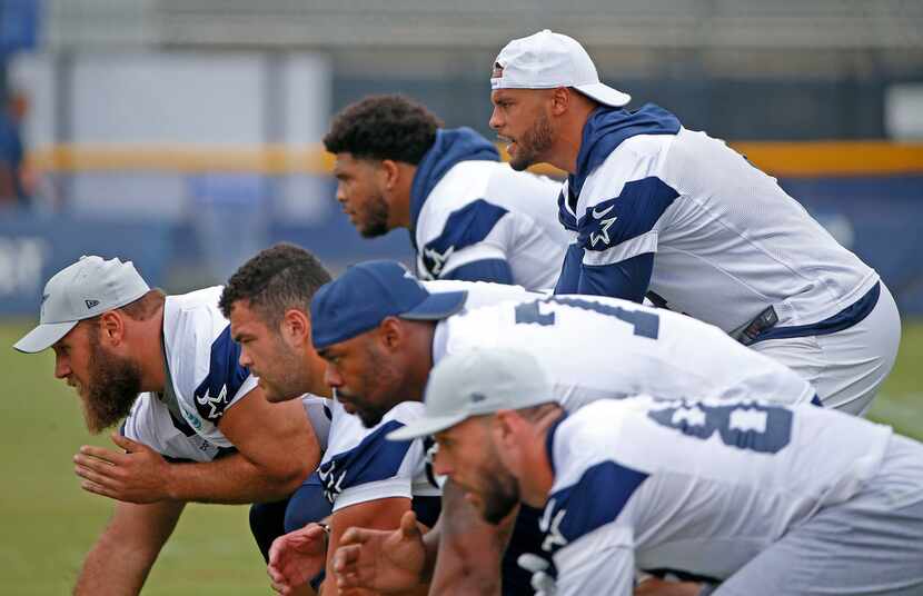 Cowboys quarterback Dak Prescott works with his offense during a morning walk-through at the...