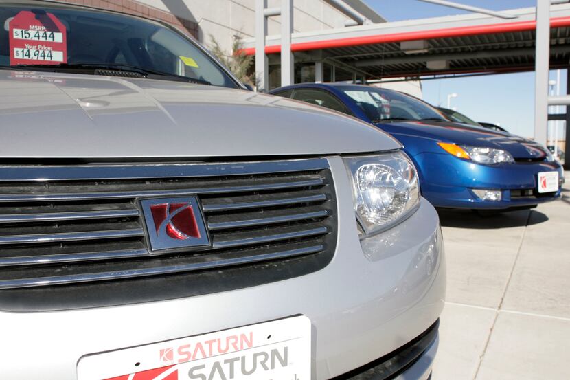 This Sunday, Nov. 19, 2006 photo shows unsold 2006 Ion coupes outside a Saturn dealership in...
